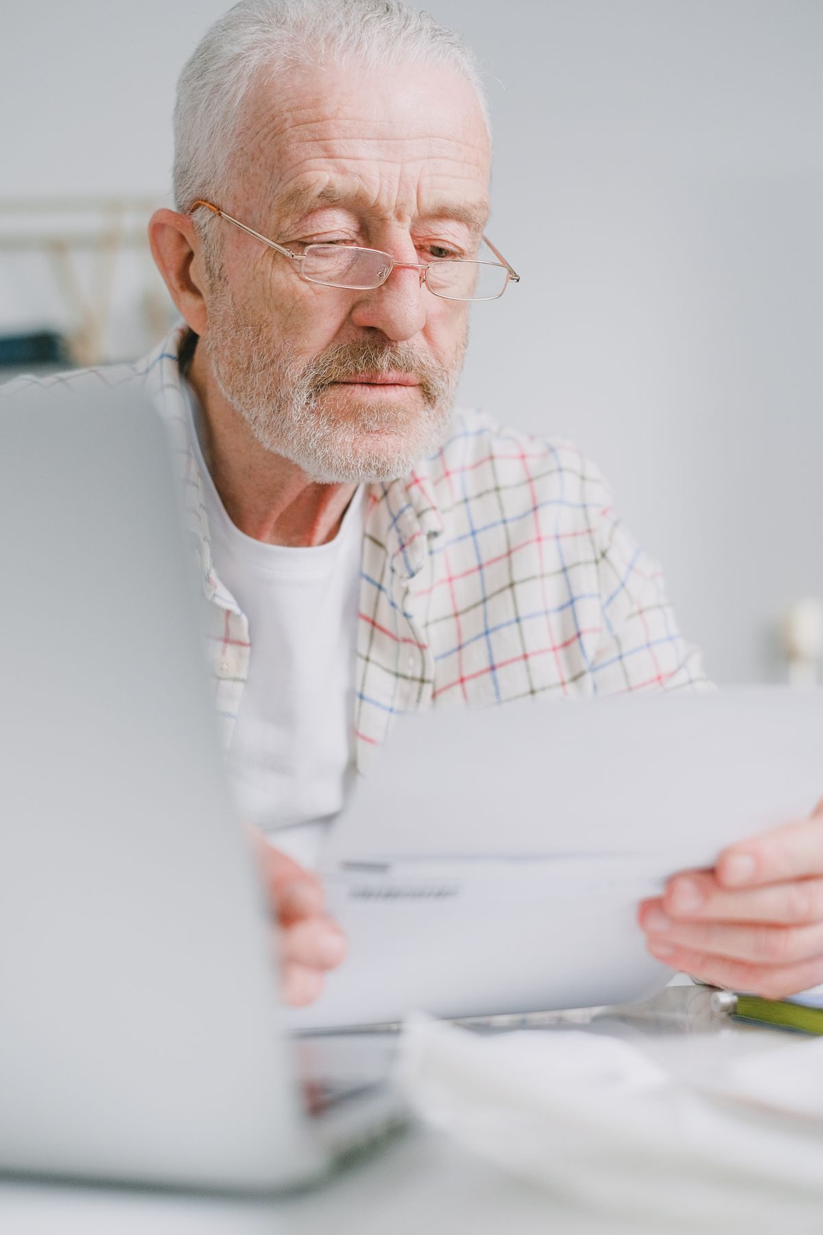 A man researching natural remedies with books and a laptop